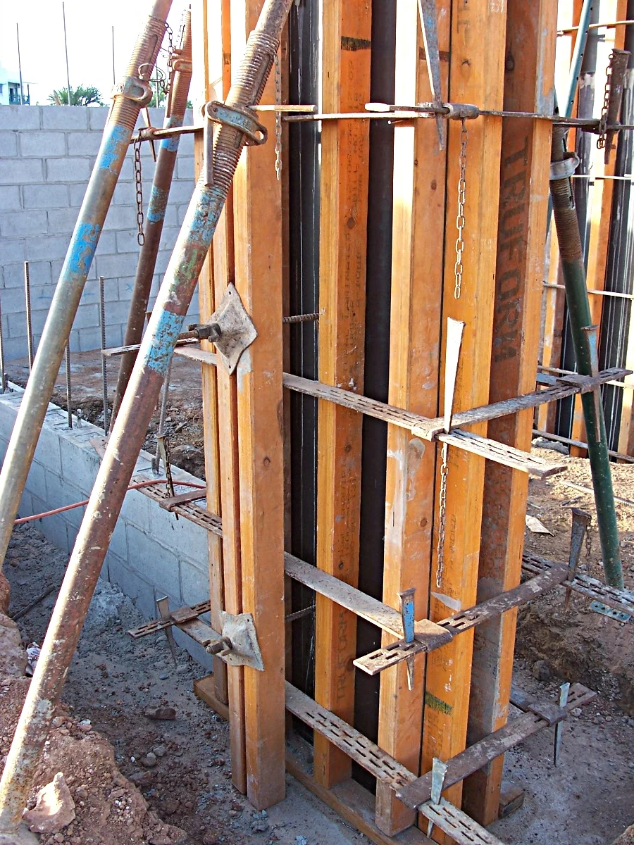Timber column formwork restrained with steel clamps and diagonal props